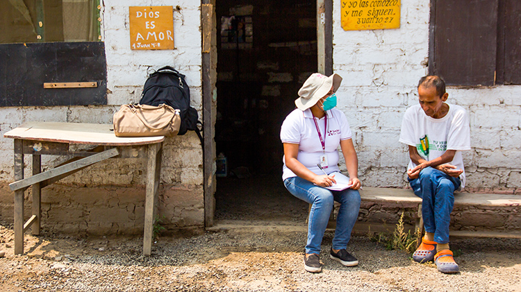 Francisco (right), a patient with MDR-TB, is provided with treatment and emotional support by Yecela Rodríguez, a field technician in the endTB project, who is visiting his group home in Carabayllo, Peru.