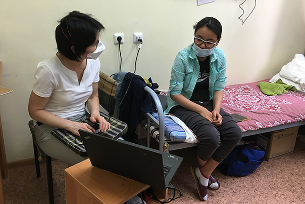 Project Coordinator Nataliya Morozova (left) and Aigerim Yekeubayeva discuss the many years she's had tuberculosis and how she's responding to a new drug regimen that includes Bedaquiline, in Almaty, Kazakhstan. Photo by Askar Yedilbayev / Partners In Health