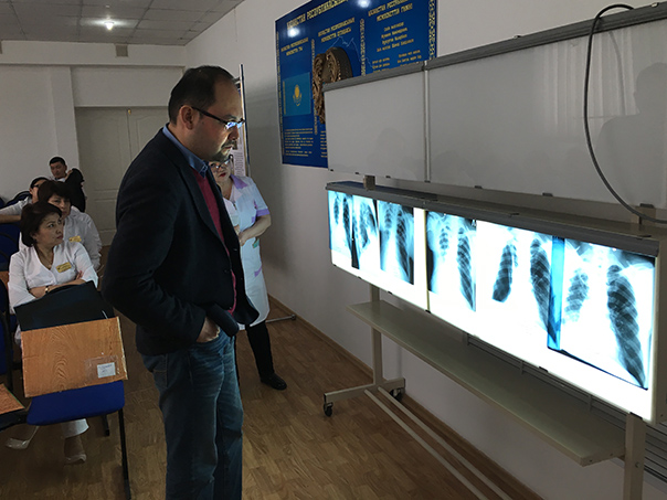 Program Director Dr. Askar Yedilbayev reviews the lung x-rays of a patient enrolled in the endTB program in Astana, Kazakhstan. Photo by Yerkebulan Algozhin / Partners In Health